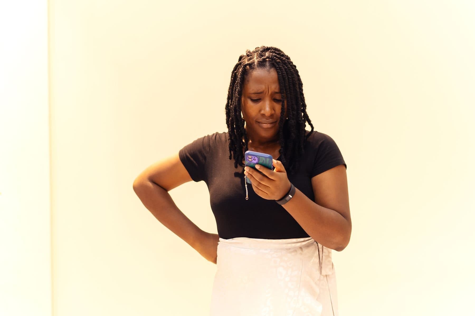 A smiling woman using her phone